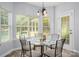 Charming breakfast nook with a glass-top table, backyard views, and natural light at 461 Pier Point Nw Ct, Concord, NC 28027