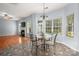 Bright breakfast nook featuring a glass-top table, decorative chandelier, and backyard views at 461 Pier Point Nw Ct, Concord, NC 28027
