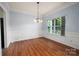 Traditional dining room showcasing hardwood floors, chair rail molding, and a stylish chandelier at 461 Pier Point Nw Ct, Concord, NC 28027