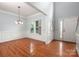 Bright dining room featuring hardwood floors, a classic chandelier, and ample natural light at 461 Pier Point Nw Ct, Concord, NC 28027
