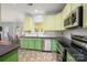 A sunny kitchen boasting modern appliances and colorful cabinetry with an adjacent breakfast nook at 461 Pier Point Nw Ct, Concord, NC 28027