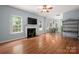 Spacious living room featuring a fireplace, hardwood floors, and ample natural light at 461 Pier Point Nw Ct, Concord, NC 28027