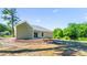 Large level backyard with fresh fill dirt, patio area, and mature trees at 503 Eddleman Rd, Kannapolis, NC 28083