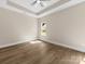 Bright bedroom with ceiling fan, wood-look flooring, and natural light from the window at 503 Eddleman Rd, Kannapolis, NC 28083