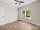 Bright bedroom features ceiling fan, wood-look flooring and double window at 503 Eddleman Rd, Kannapolis, NC 28083