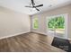 Bright bedroom features a ceiling fan, sliding glass door to patio, and wood-look flooring at 503 Eddleman Rd, Kannapolis, NC 28083