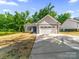 Charming single-Gathering home featuring a two-car garage and manicured lawn in a suburban neighborhood at 503 Eddleman Rd, Kannapolis, NC 28083