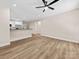 Open-concept living room featuring modern flooring and a view of the kitchen with bar seating at 503 Eddleman Rd, Kannapolis, NC 28083