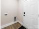 Practical mudroom area with door, wood-look flooring, and utility connections at 503 Eddleman Rd, Kannapolis, NC 28083