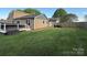 Spacious backyard with a well-maintained lawn, deck, hot tub, and privacy fence at 5050 Forest Ridge Dr, Hickory, NC 28602