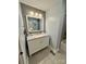 A bathroom features a single vanity, white cabinets, wood-look accent wall and neutral paint at 5050 Forest Ridge Dr, Hickory, NC 28602