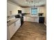 A modern kitchen features bright white cabinets, a tile backsplash and stainless steel appliances at 5050 Forest Ridge Dr, Hickory, NC 28602