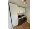 Laundry area with cabinets, front load washer and dryer, and an ironing board at 5050 Forest Ridge Dr, Hickory, NC 28602