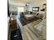 Spacious living room featuring a gray sectional sofa, stone fireplace, and modern decor at 5050 Forest Ridge Dr, Hickory, NC 28602