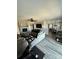 Open-concept living room with a stone fireplace, gray sofa, ceiling fan, and views of the dining area at 5050 Forest Ridge Dr, Hickory, NC 28602