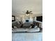 Cozy living room featuring a stone fireplace, gray sectional sofa, and wood-look floors at 5050 Forest Ridge Dr, Hickory, NC 28602