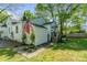 Charming backyard featuring an American flag, storage shed, and well-manicured lawn and landscaping at 56 Blume Sw Ave, Concord, NC 28025
