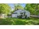 Spacious backyard showcasing a wooden deck, lush lawn, and a charming white house at 56 Blume Sw Ave, Concord, NC 28025