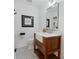 Charming bathroom with black and white hexagon tile, wood cabinet, and a modern sink at 56 Blume Sw Ave, Concord, NC 28025
