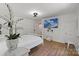 Bright bedroom featuring hardwood floors, wainscoting, and a wall-mounted television above a modern bed at 56 Blume Sw Ave, Concord, NC 28025