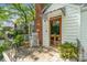 Inviting front entrance with a brick chimney, a rocking chair on the patio and a wood door with glass at 56 Blume Sw Ave, Concord, NC 28025