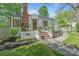Charming home featuring a brick chimney, black and white awning, brick steps, and mature landscaping at 56 Blume Sw Ave, Concord, NC 28025