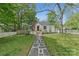 Quaint home showcasing a landscaped front yard, a brick chimney, and a charming picket fence at 56 Blume Sw Ave, Concord, NC 28025