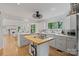 Bright open kitchen with white cabinets, butcher block island, stainless appliances, and hardwood floors at 56 Blume Sw Ave, Concord, NC 28025