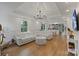 Bright living room with a tray ceiling and an open floor plan view into the white kitchen and dining area at 56 Blume Sw Ave, Concord, NC 28025