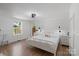 Bright, spacious main bedroom featuring hardwood floors, a ceiling fan, and natural light from the window at 56 Blume Sw Ave, Concord, NC 28025