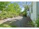 Gravel side yard features wood pallet planters, fence and a glimpse of a green lawn beyond at 56 Blume Sw Ave, Concord, NC 28025