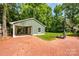 Charming backyard featuring a detached garage, carport, basketball court and beautiful green lawn at 5916 Rexwood Pl, Charlotte, NC 28210