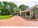 Expansive backyard showing brick patio, enclosed porch, basketball hoop and lush landscaping at 5916 Rexwood Pl, Charlotte, NC 28210