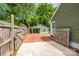View of the backyard featuring a detached garage with carport, and a wood fence at 5916 Rexwood Pl, Charlotte, NC 28210
