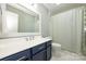 This bathroom features a large vanity, modern fixtures, and a shower with a curtain at 5916 Rexwood Pl, Charlotte, NC 28210