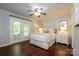 Cozy bedroom with hardwood floors, french doors, and ensuite bathroom with neutral paint and lots of light at 5916 Rexwood Pl, Charlotte, NC 28210