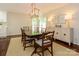 Elegant dining room featuring a modern chandelier and ample natural light at 5916 Rexwood Pl, Charlotte, NC 28210