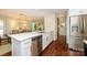 Kitchen featuring stainless appliances, island with seating, hardwood floors, and modern white cabinetry and finishes at 5916 Rexwood Pl, Charlotte, NC 28210