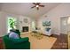 Bright living room featuring a painted fireplace, hardwood floors, and vaulted ceilings at 5916 Rexwood Pl, Charlotte, NC 28210