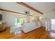 Spacious living room with hardwood floors, wood beams, bay windows and a comfortable seating area with lots of light at 5916 Rexwood Pl, Charlotte, NC 28210