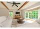 Bright living room features wood beams, hardwood floors, bay windows, tv and comfortable seating area at 5916 Rexwood Pl, Charlotte, NC 28210