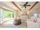 Bright living room features wood beams, hardwood floors, bay windows and a comfortable sectional sofa at 5916 Rexwood Pl, Charlotte, NC 28210