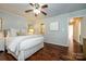 The bright main bedroom offers hardwood floors and a view into the main bathroom at 5916 Rexwood Pl, Charlotte, NC 28210