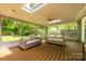 Screened-in back porch with comfortable seating and a ceiling fan at 5916 Rexwood Pl, Charlotte, NC 28210