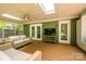 Back porch with comfortable seating, a ceiling fan and a mounted TV at 5916 Rexwood Pl, Charlotte, NC 28210