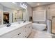 Bathroom featuring a double vanity sink, a freestanding soaking tub, a frameless glass shower, and modern fixtures at 604 Airport Rd, Kannapolis, NC 28081
