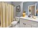 Bathroom featuring a shower with a curtain, white tiled floors, and a vanity sink with a mirror at 604 Airport Rd, Kannapolis, NC 28081