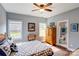 Bright bedroom features natural light, a ceiling fan, and an attached bathroom entrance at 604 Airport Rd, Kannapolis, NC 28081