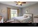 Cozy bedroom featuring wooden floors, natural lighting, and a comfortable bed with a decorative quilt at 604 Airport Rd, Kannapolis, NC 28081