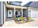Inviting front porch featuring rocking chairs, columns, and a beautifully landscaped garden, enhancing curb appeal at 604 Airport Rd, Kannapolis, NC 28081